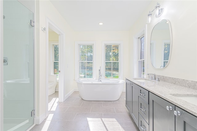 full bathroom with vanity, shower with separate bathtub, toilet, and tile patterned flooring