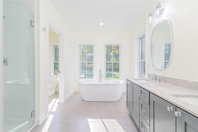 416 Bridgetown Rd, South Kingstown, RI 02874 - full bath with double vanity, baseboards, a freestanding bath, a sink, and a stall shower