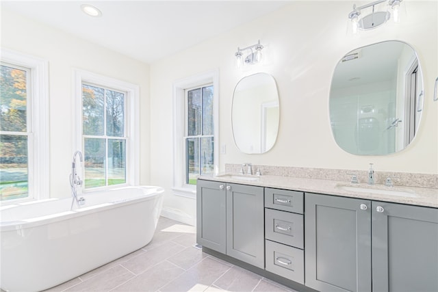 bathroom with vanity, independent shower and bath, and tile patterned flooring