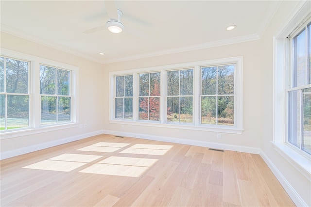 unfurnished sunroom featuring ceiling fan