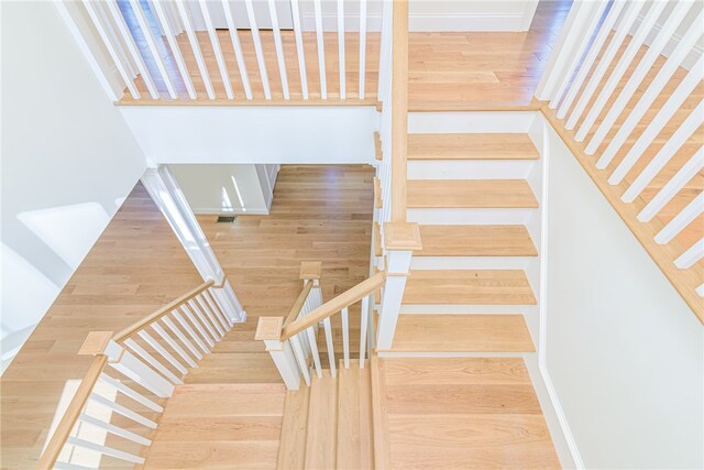 stairway featuring hardwood / wood-style flooring