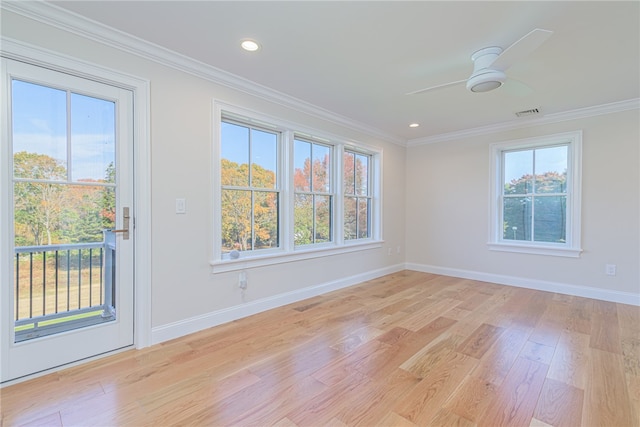 spare room with ornamental molding, light hardwood / wood-style flooring, and a healthy amount of sunlight