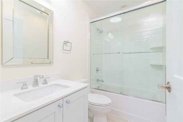 full bathroom with vanity, toilet, tile patterned floors, and combined bath / shower with glass door