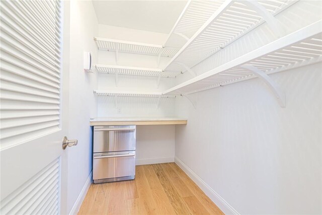 416 Bridgetown Rd, South Kingstown, RI 02874 - walk in closet with light wood-style floors and built in study area
