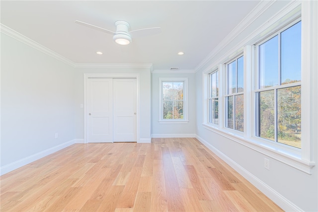 unfurnished bedroom featuring a closet, ceiling fan, crown molding, and light hardwood / wood-style floors