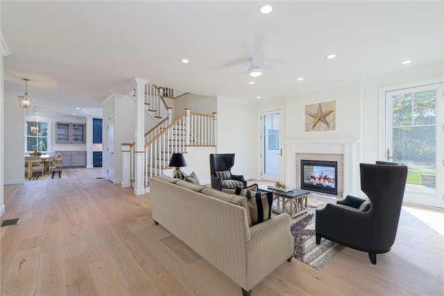 416 Bridgetown Rd, South Kingstown, RI 02874 - living room with plenty of natural light, ornamental molding, light wood-style flooring, and stairs