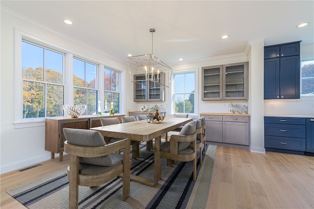 416 Bridgetown Rd, South Kingstown, RI 02874 - dining area with visible vents, ornamental molding, light wood-style flooring, and a chandelier