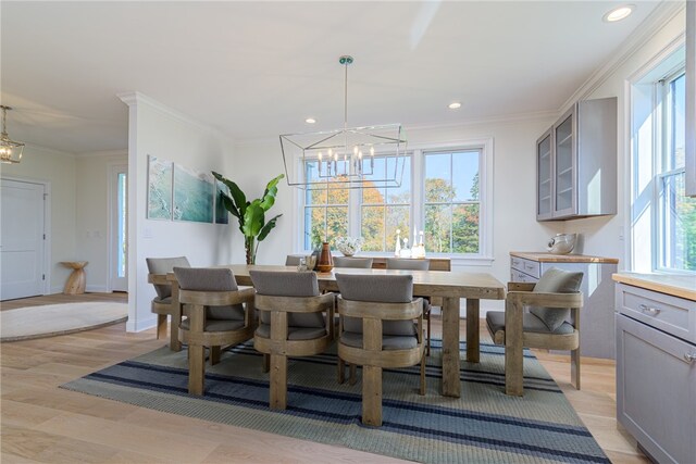 416 Bridgetown Rd, South Kingstown, RI 02874 - dining space with a notable chandelier, ornamental molding, a wealth of natural light, and light wood-style floors