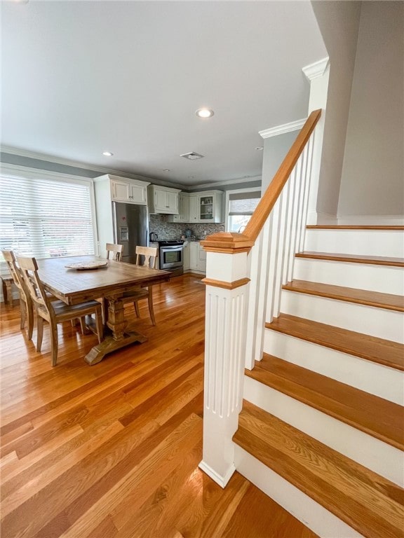 stairway with hardwood / wood-style floors