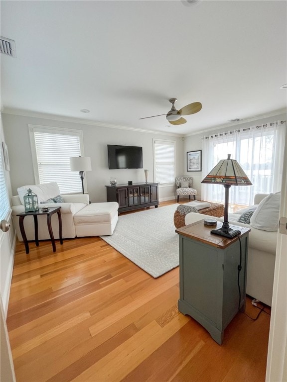 living room featuring hardwood / wood-style floors, a healthy amount of sunlight, and ceiling fan