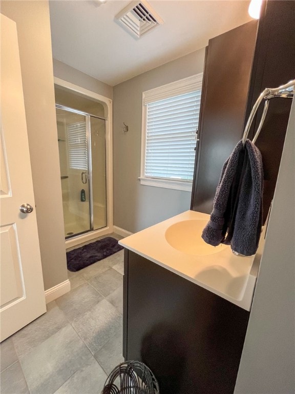 bathroom with vanity, walk in shower, and tile patterned floors