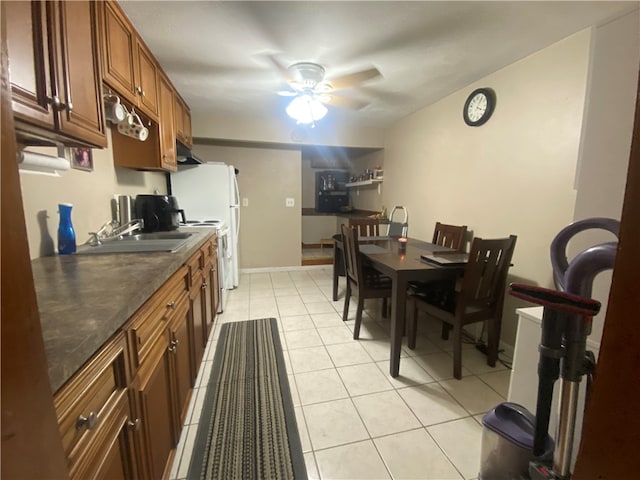 kitchen featuring sink, ceiling fan, and light tile patterned floors