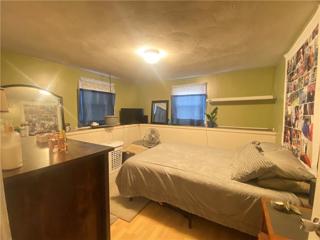 bedroom featuring a textured ceiling and hardwood / wood-style flooring