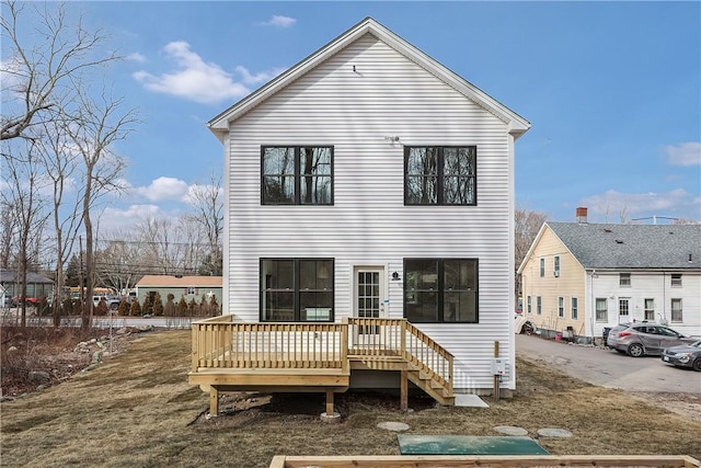 back of house featuring a deck