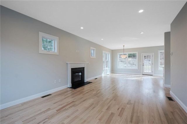 unfurnished living room featuring light wood-type flooring