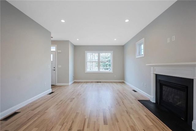 unfurnished living room featuring light wood-type flooring