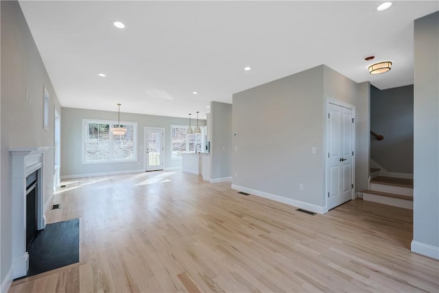 unfurnished living room featuring light wood-type flooring