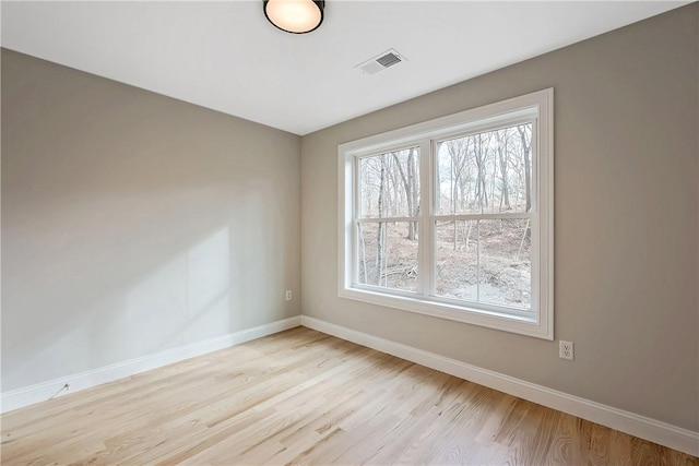 unfurnished room with light hardwood / wood-style floors