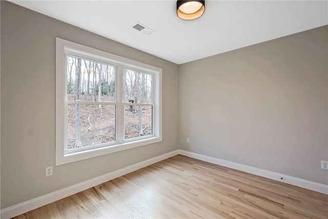 unfurnished room with light hardwood / wood-style flooring