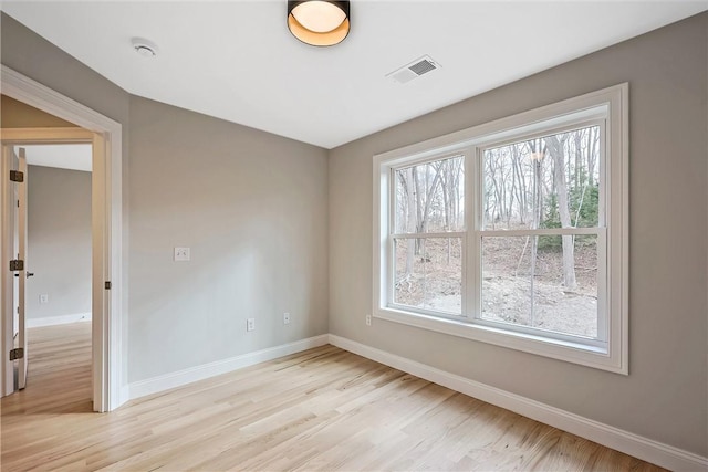 unfurnished room featuring light hardwood / wood-style floors