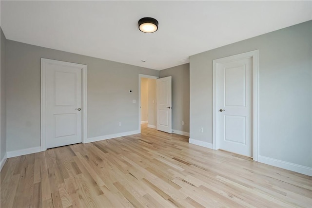 unfurnished bedroom featuring light wood-type flooring