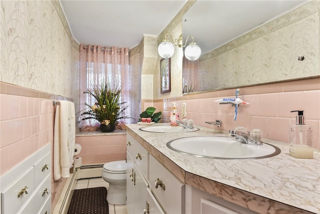 bathroom with toilet, tile patterned floors, tile walls, baseboard heating, and vanity