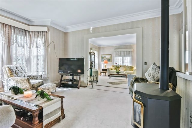 carpeted living room with a wood stove and ornamental molding