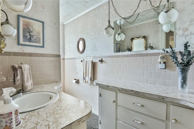 bathroom featuring vanity, ornamental molding, and tile walls