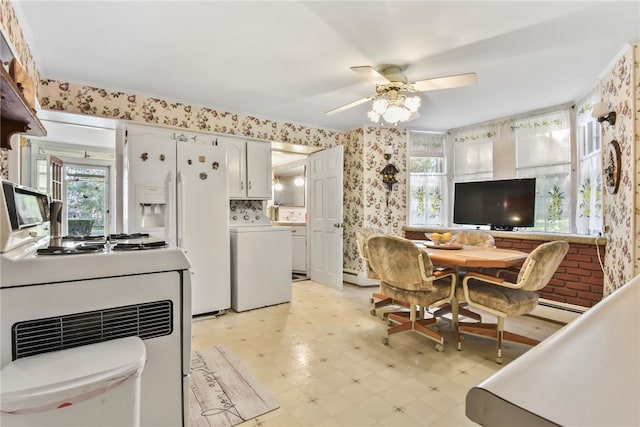 kitchen with washer / clothes dryer, range, ceiling fan, baseboard heating, and white cabinets