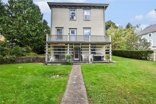 rear view of property with a yard