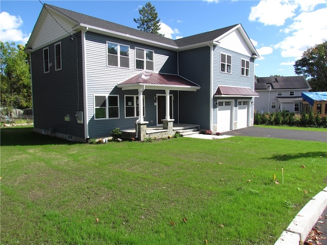 view of front of property with a front yard and a garage