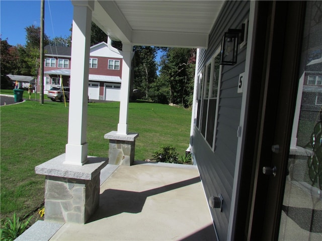 view of patio featuring covered porch and a garage