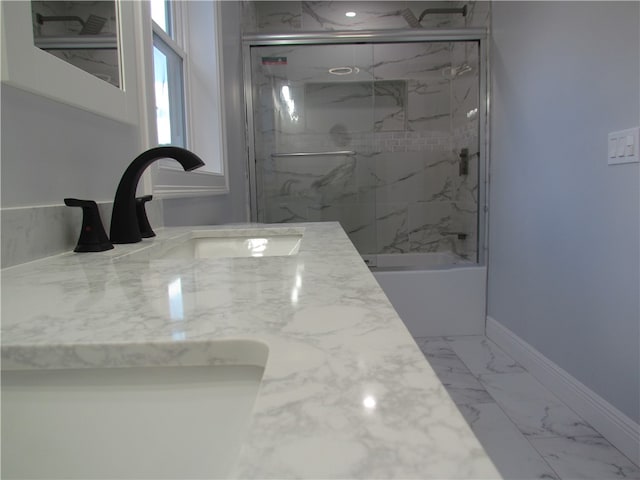 bathroom with vanity and bath / shower combo with glass door