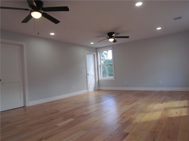 spare room featuring light hardwood / wood-style flooring and ceiling fan