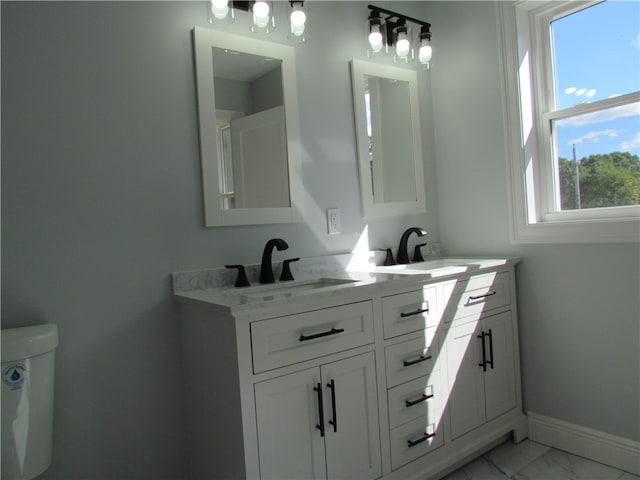 bathroom featuring vanity and toilet