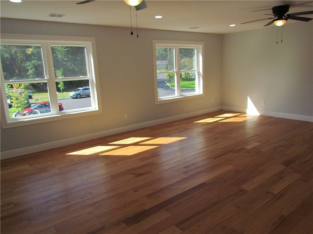 spare room with ceiling fan and dark hardwood / wood-style flooring