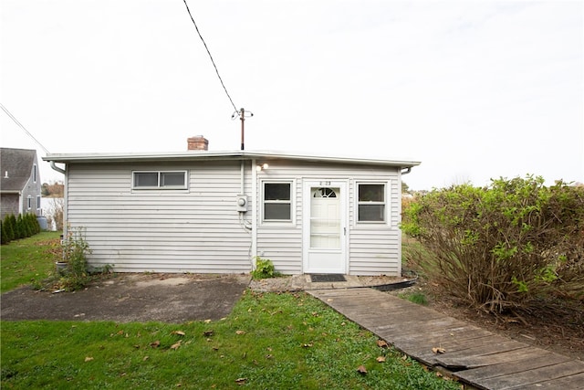 view of outbuilding with a lawn