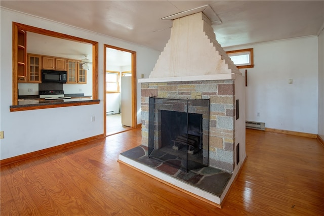 unfurnished living room featuring a stone fireplace, light hardwood / wood-style flooring, and a wealth of natural light