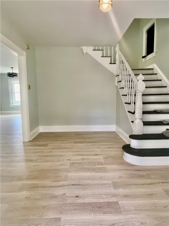 staircase with hardwood / wood-style flooring