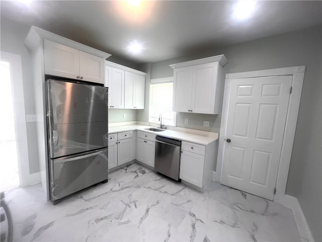 kitchen with white cabinets, sink, and appliances with stainless steel finishes