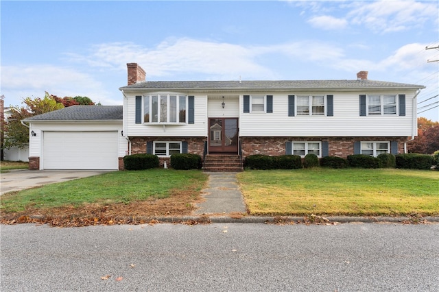 split foyer home with a garage and a front lawn