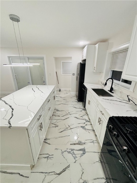 kitchen featuring black appliances, sink, decorative light fixtures, and white cabinets