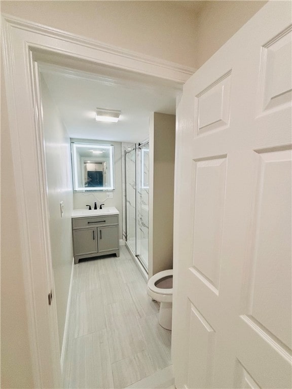 bathroom featuring walk in shower, vanity, and toilet