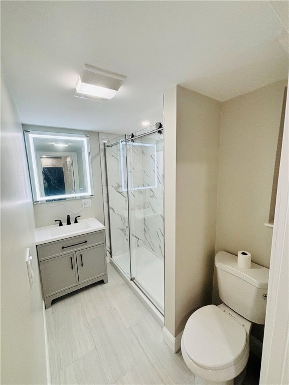 bathroom with walk in shower, vanity, and toilet