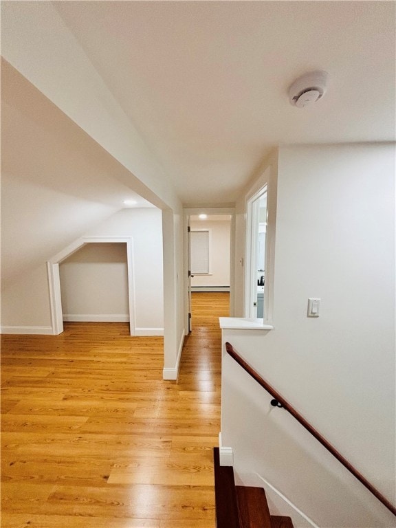 corridor with light hardwood / wood-style floors