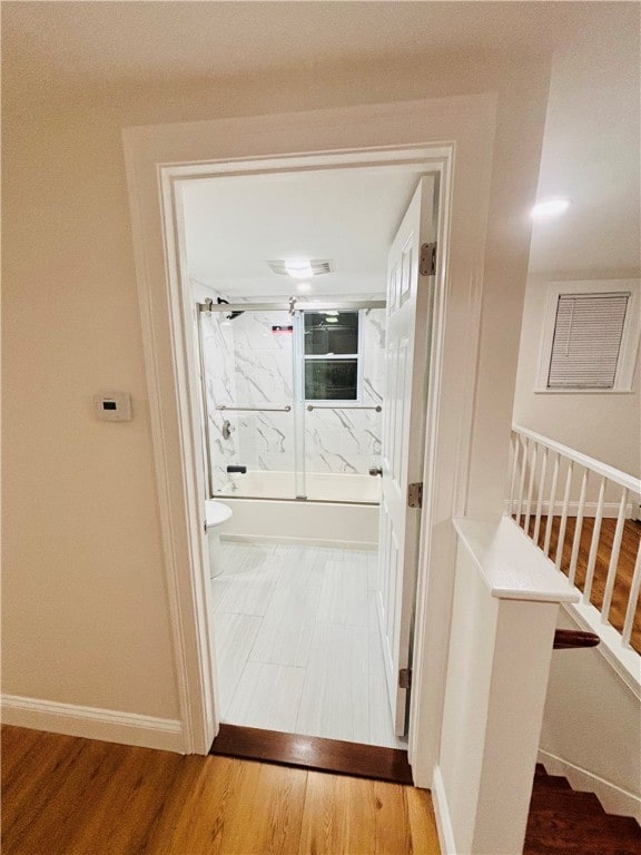 hallway with wood-type flooring