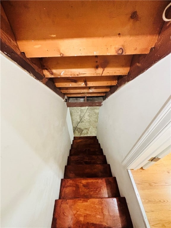 stairs featuring beam ceiling