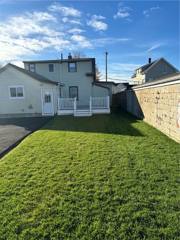 rear view of property with a lawn