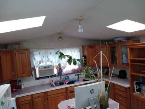 kitchen with vaulted ceiling with skylight