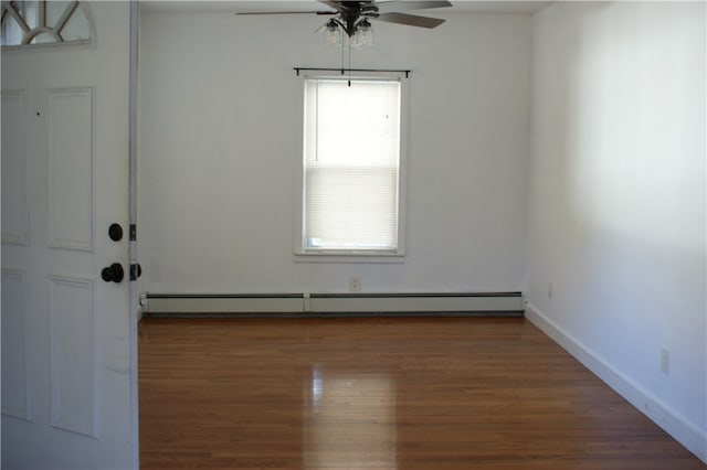 empty room featuring a baseboard radiator, dark wood-type flooring, and ceiling fan